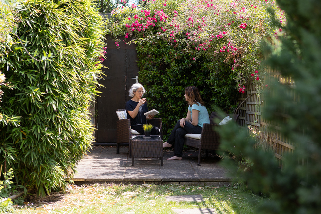Yasmin talking to a client in the garden